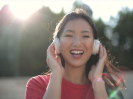 Smiling girl in red crew neck shirt with headphones